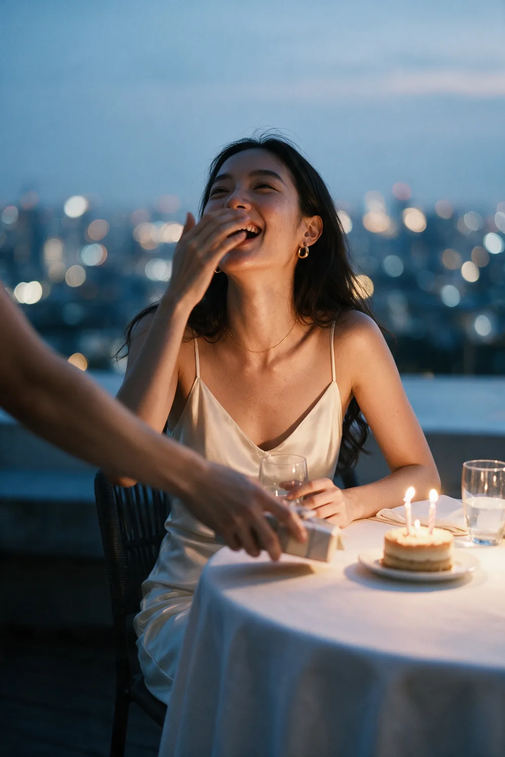 A birthday on a rooftop, the city out of focus behind.