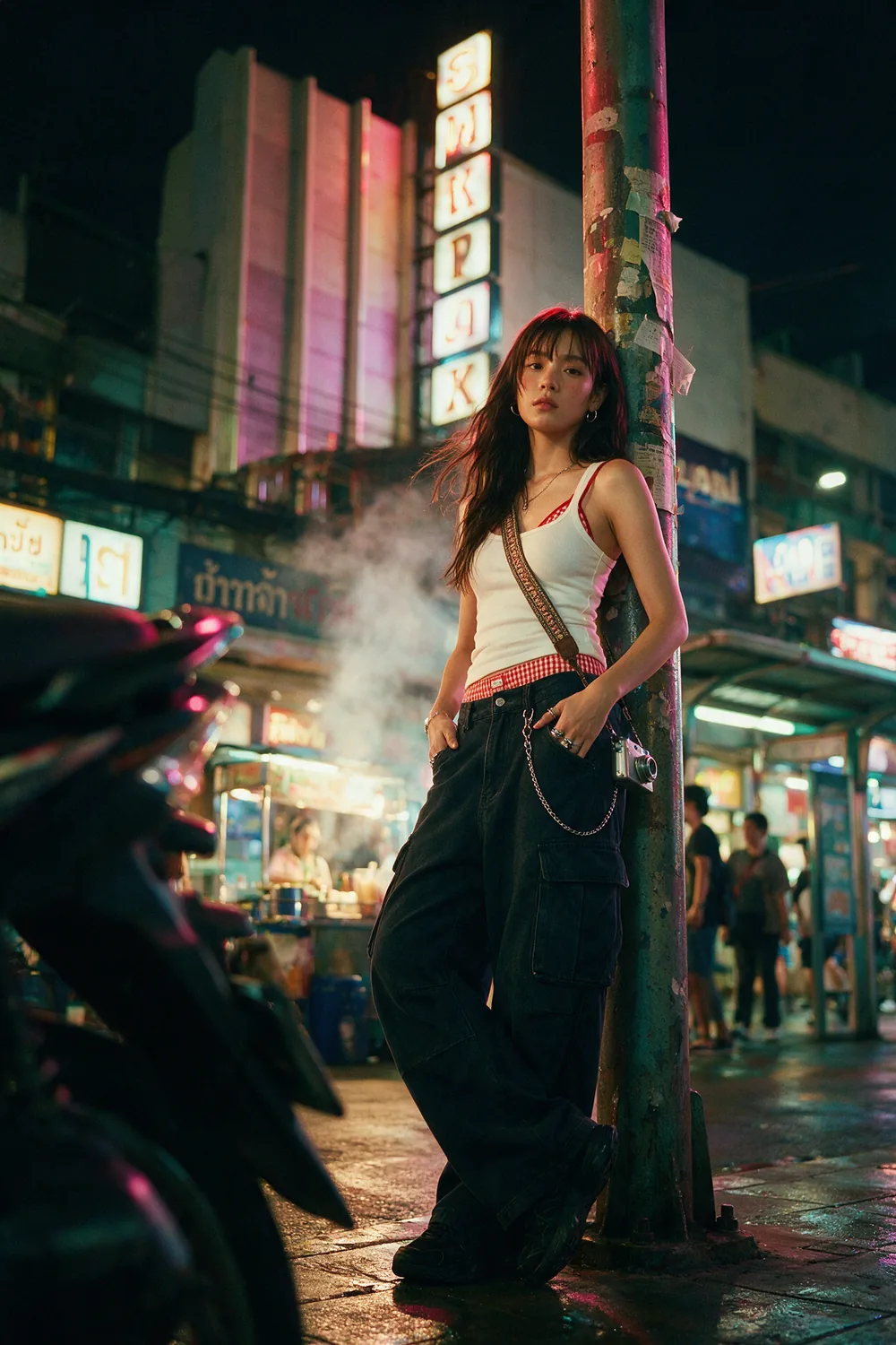 Standing against a pillar under the neon.